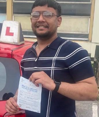 Almin holding their practical driving test pass certificate after passing with MK Driving School in East London, June 2026