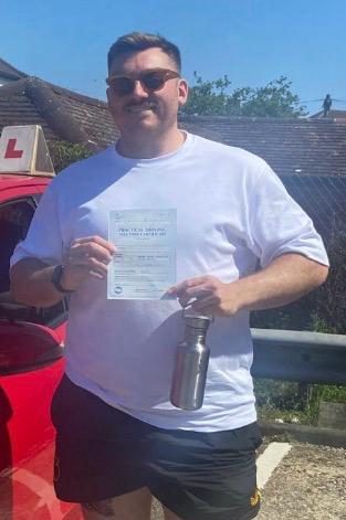 Connor holding their practical driving test pass certificate after passing with MK Driving School in East London, May 2025