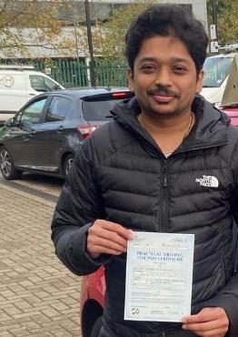 Harsh holding their practical driving test pass certificate after passing with MK Driving School in East London, November 2025