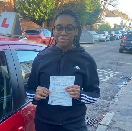 Jassica holding their practical driving test pass certificate after passing with MK Driving School in East London, December 2025