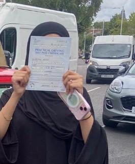A pupil holding their practical driving test pass certificate after passing with MK Driving School in East London, September 2025