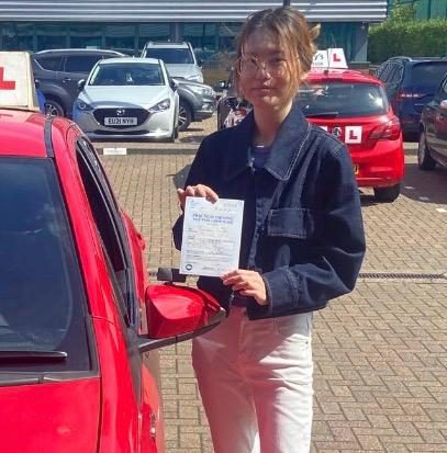 Sharon holding their practical driving test pass certificate after passing with MK Driving School in East London, May 2025